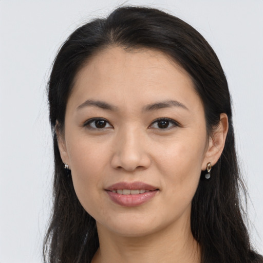 Joyful asian young-adult female with long  brown hair and brown eyes