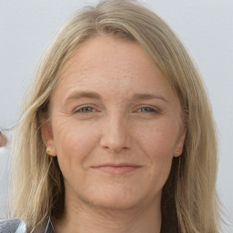 Joyful white adult female with long  brown hair and grey eyes