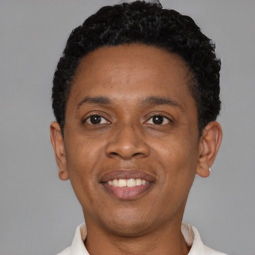 Joyful black young-adult male with short  black hair and brown eyes