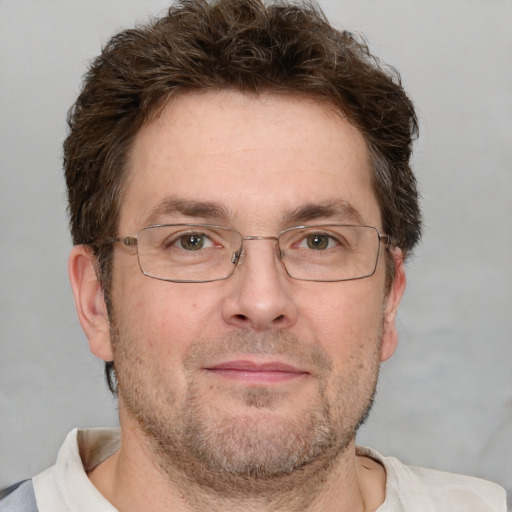 Joyful white adult male with short  brown hair and grey eyes