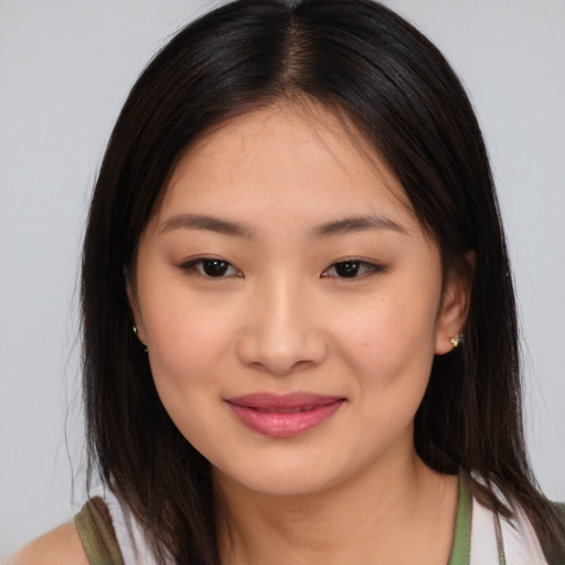 Joyful asian young-adult female with long  brown hair and brown eyes