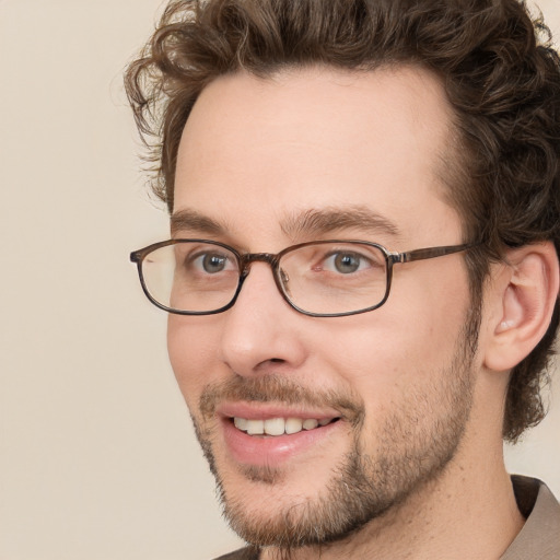 Joyful white young-adult male with short  brown hair and green eyes