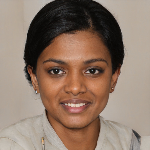 Joyful black young-adult female with medium  black hair and brown eyes