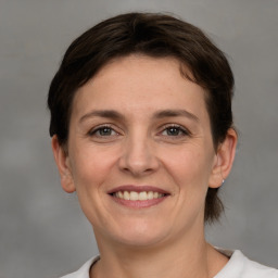 Joyful white young-adult female with short  brown hair and grey eyes