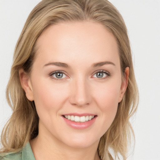 Joyful white young-adult female with medium  brown hair and blue eyes