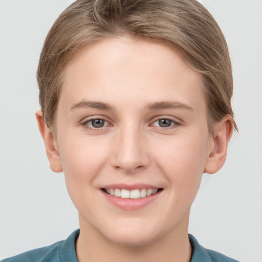 Joyful white young-adult female with short  brown hair and grey eyes