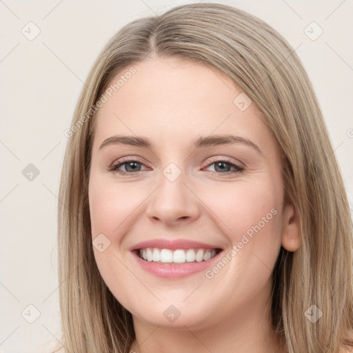 Joyful white young-adult female with long  brown hair and grey eyes