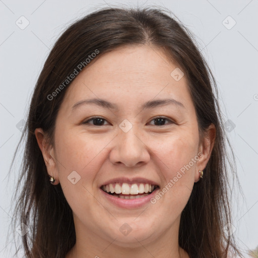 Joyful white adult female with long  brown hair and brown eyes