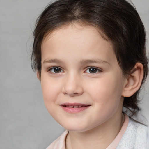 Joyful white child female with medium  brown hair and brown eyes