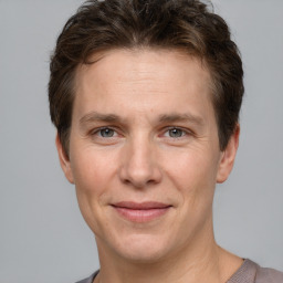 Joyful white adult male with short  brown hair and grey eyes