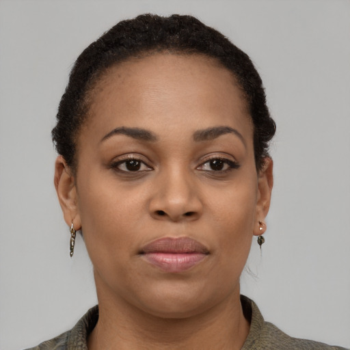 Joyful black young-adult female with short  black hair and brown eyes