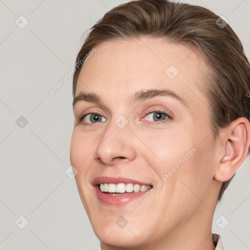 Joyful white young-adult female with short  brown hair and grey eyes