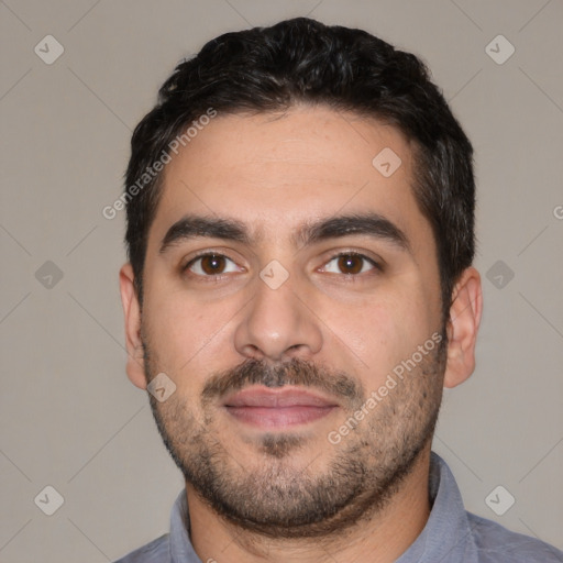 Joyful white young-adult male with short  black hair and brown eyes