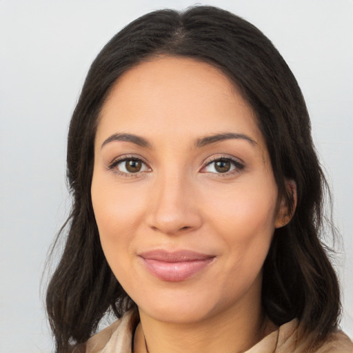 Joyful latino young-adult female with long  brown hair and brown eyes