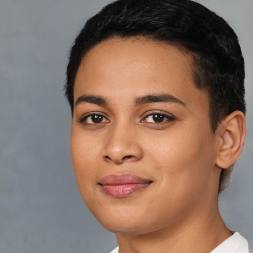 Joyful latino young-adult female with short  black hair and brown eyes