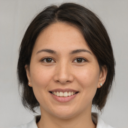 Joyful white young-adult female with medium  brown hair and brown eyes