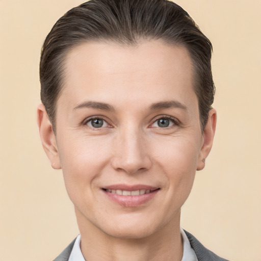 Joyful white adult female with short  brown hair and grey eyes