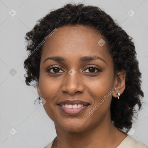 Joyful black young-adult female with long  black hair and brown eyes