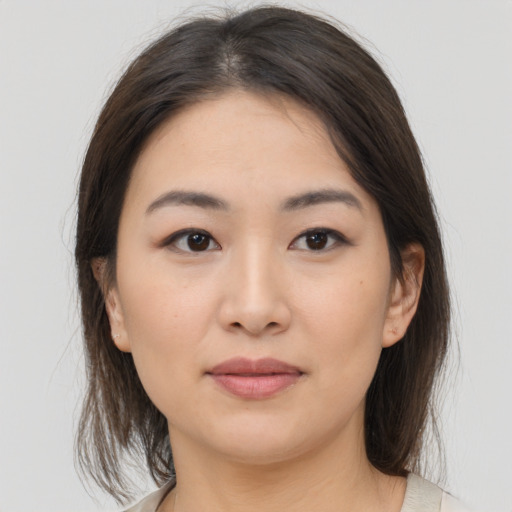 Joyful asian young-adult female with medium  brown hair and brown eyes