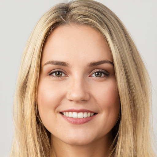 Joyful white young-adult female with long  brown hair and green eyes