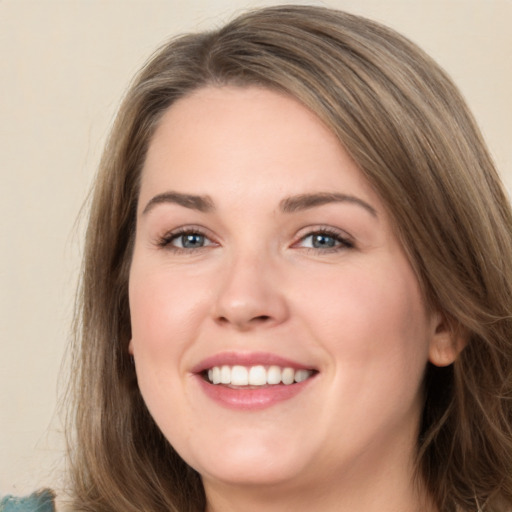 Joyful white young-adult female with long  brown hair and green eyes