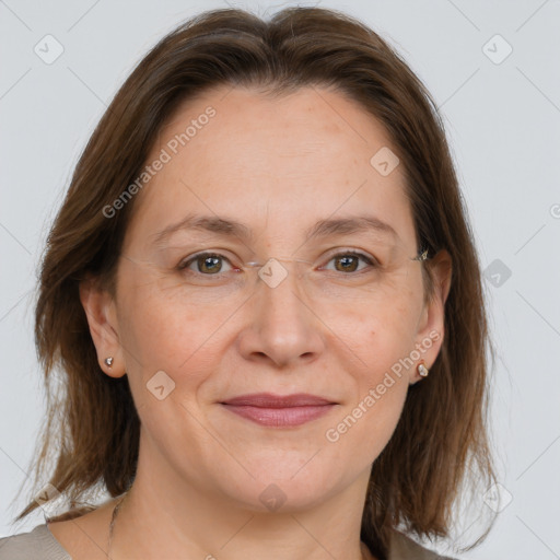 Joyful white adult female with medium  brown hair and grey eyes