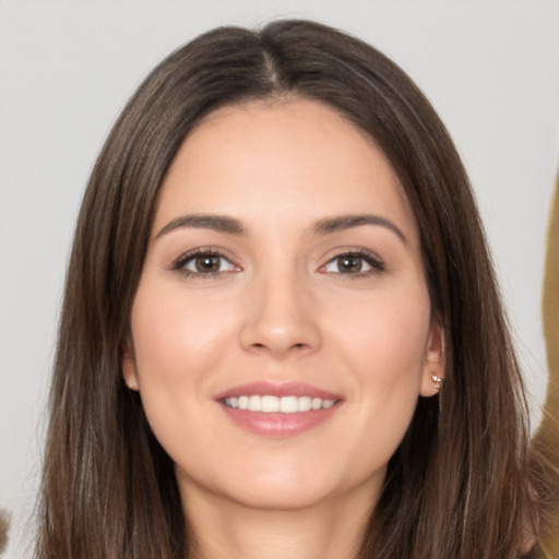 Joyful white young-adult female with long  brown hair and brown eyes