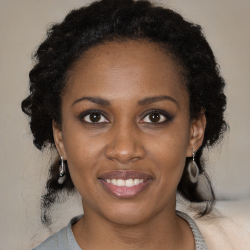 Joyful black young-adult female with medium  black hair and brown eyes