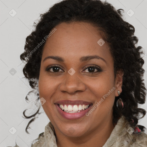 Joyful black young-adult female with long  brown hair and brown eyes