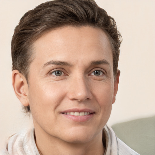 Joyful white adult male with short  brown hair and grey eyes