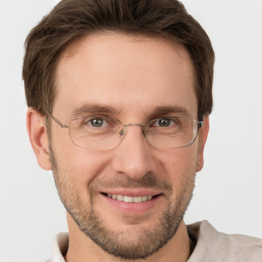 Joyful white adult male with short  brown hair and grey eyes