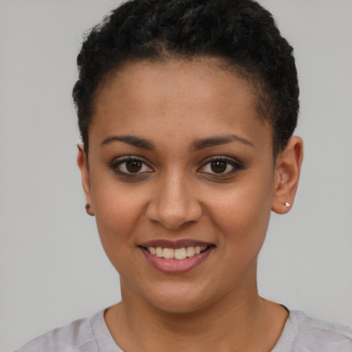 Joyful latino young-adult female with short  brown hair and brown eyes
