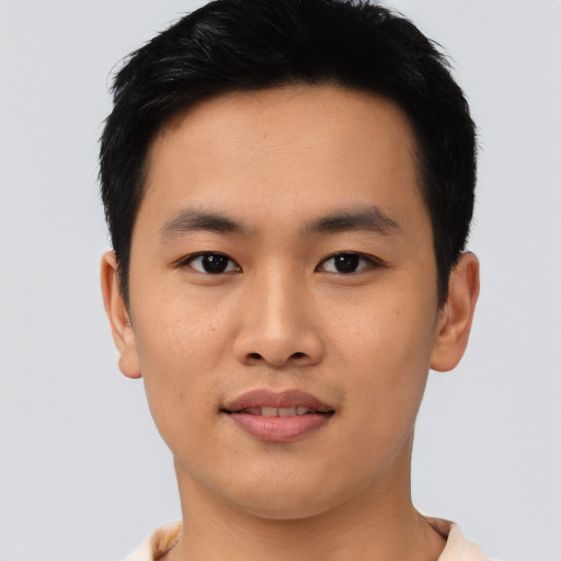 Joyful asian young-adult male with short  black hair and brown eyes