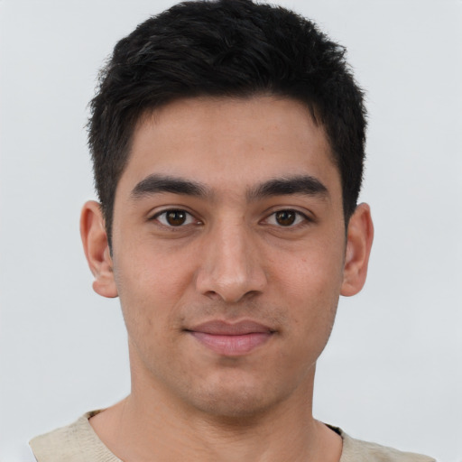 Joyful latino young-adult male with short  black hair and brown eyes