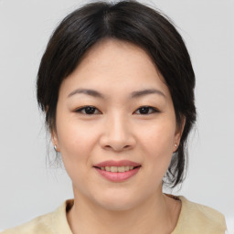 Joyful asian young-adult female with medium  brown hair and brown eyes