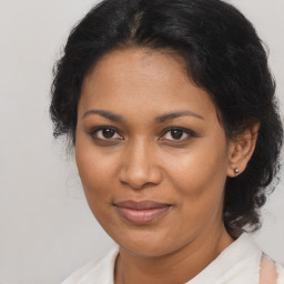 Joyful black young-adult female with medium  brown hair and brown eyes