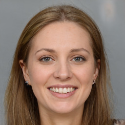 Joyful white young-adult female with long  brown hair and grey eyes