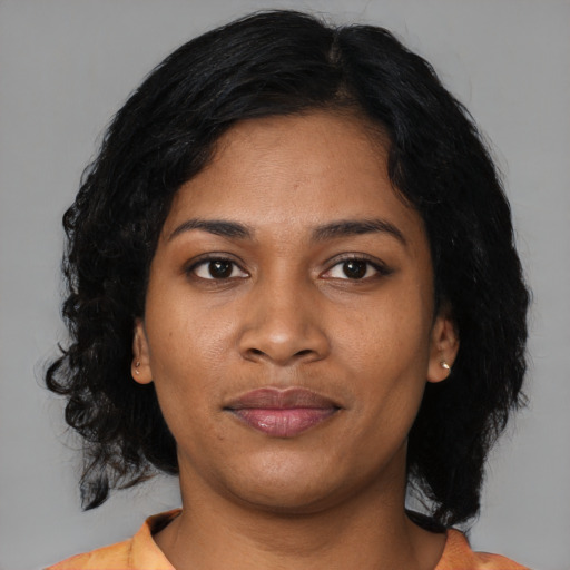 Joyful black young-adult female with medium  black hair and brown eyes