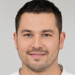 Joyful white young-adult male with short  brown hair and brown eyes