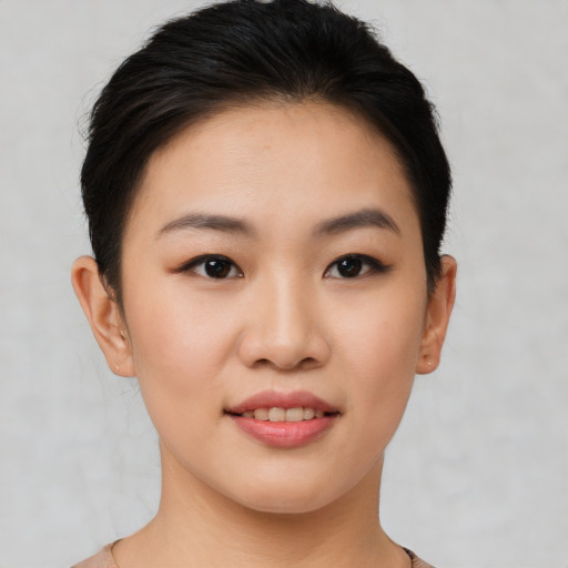 Joyful asian young-adult female with short  black hair and brown eyes