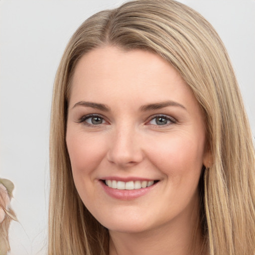 Joyful white young-adult female with long  brown hair and brown eyes