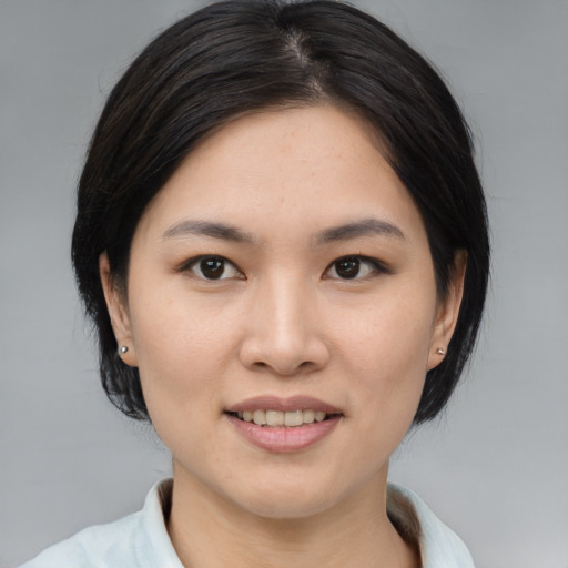 Joyful asian young-adult female with medium  brown hair and brown eyes