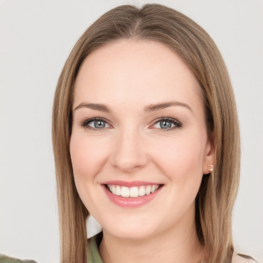 Joyful white young-adult female with medium  brown hair and green eyes