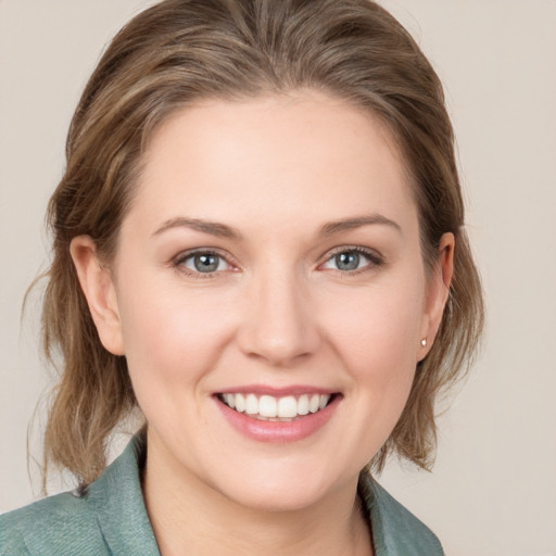 Joyful white young-adult female with medium  brown hair and grey eyes