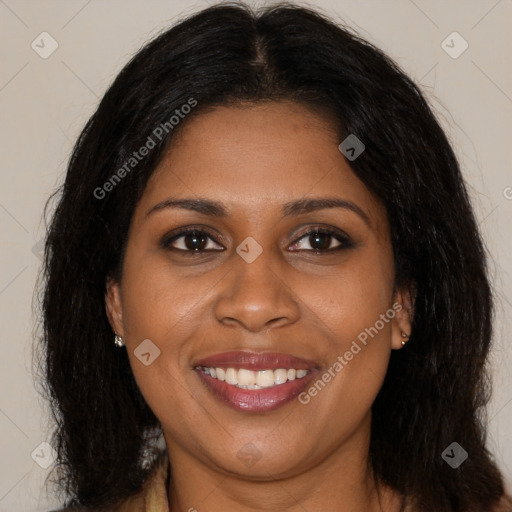 Joyful black young-adult female with long  brown hair and brown eyes