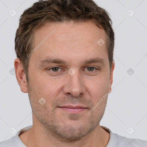 Joyful white adult male with short  brown hair and brown eyes