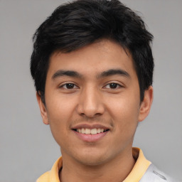 Joyful latino young-adult male with short  black hair and brown eyes