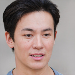 Joyful asian young-adult male with short  brown hair and brown eyes