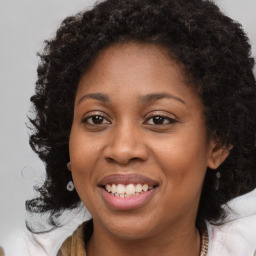 Joyful black young-adult female with medium  brown hair and brown eyes