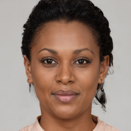 Joyful black adult female with short  brown hair and brown eyes